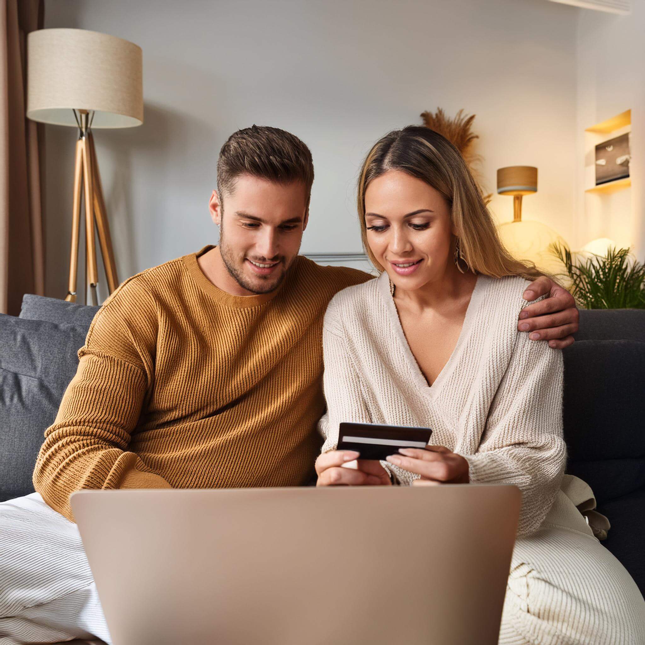 Image of young couple shopping online from home.